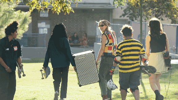 A group carrying a SOUNDBOKS in a park